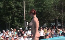 Ravishing redhead performs striptease in public