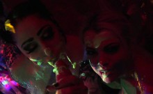 Black-light babes Nadia and Ophelia suck off a colorful cock