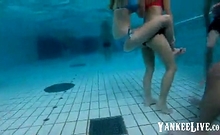 girsl underwater at pool